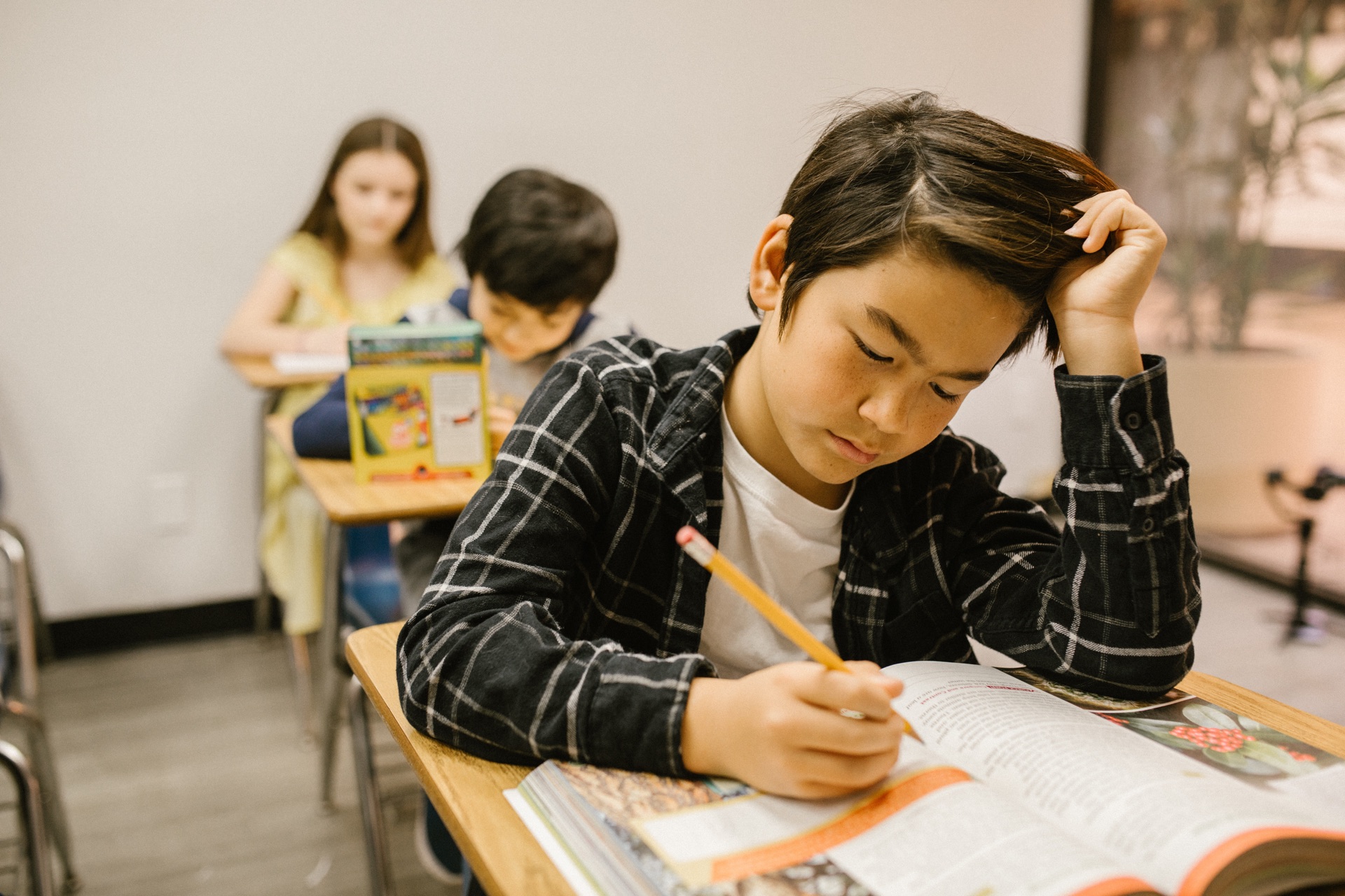 Focused young student working diligently on practice study materials